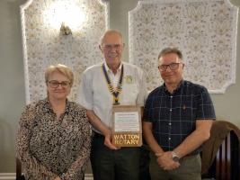 Paul and Marian Adcock receive trophy from Rotary Club President Mike Gicquel